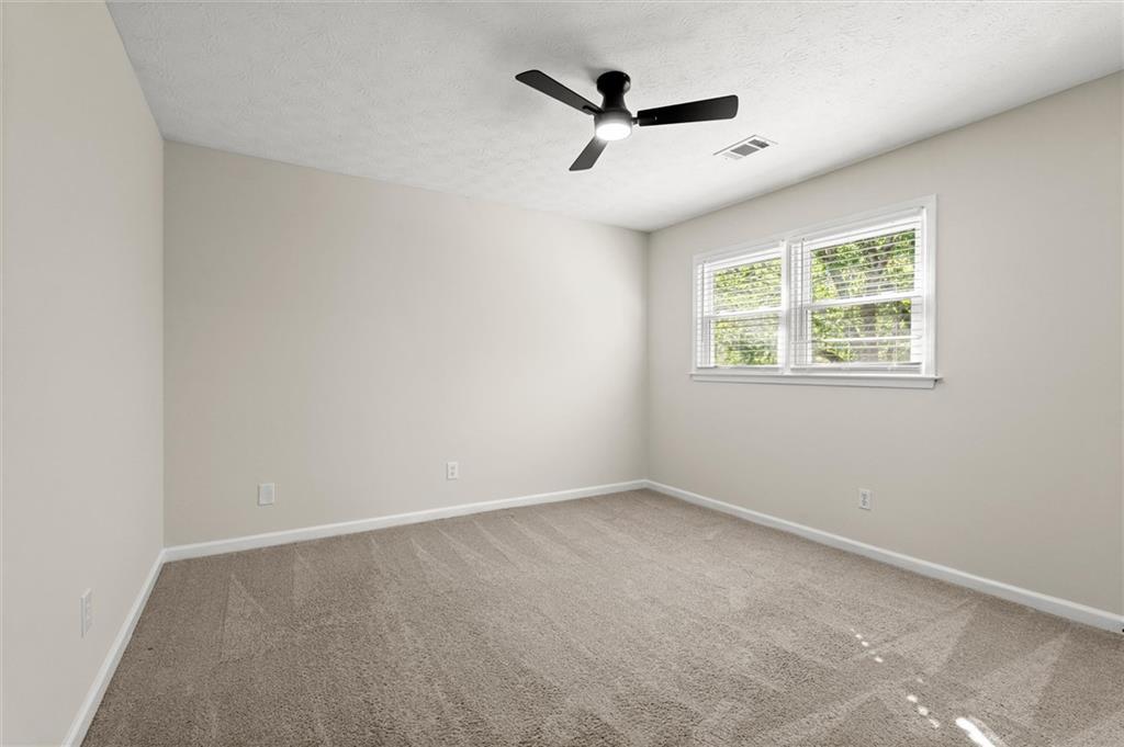 4922 Signal Court Southwest Lilburn, GA 30047 - Photo 36 of 49 an empty room with windows