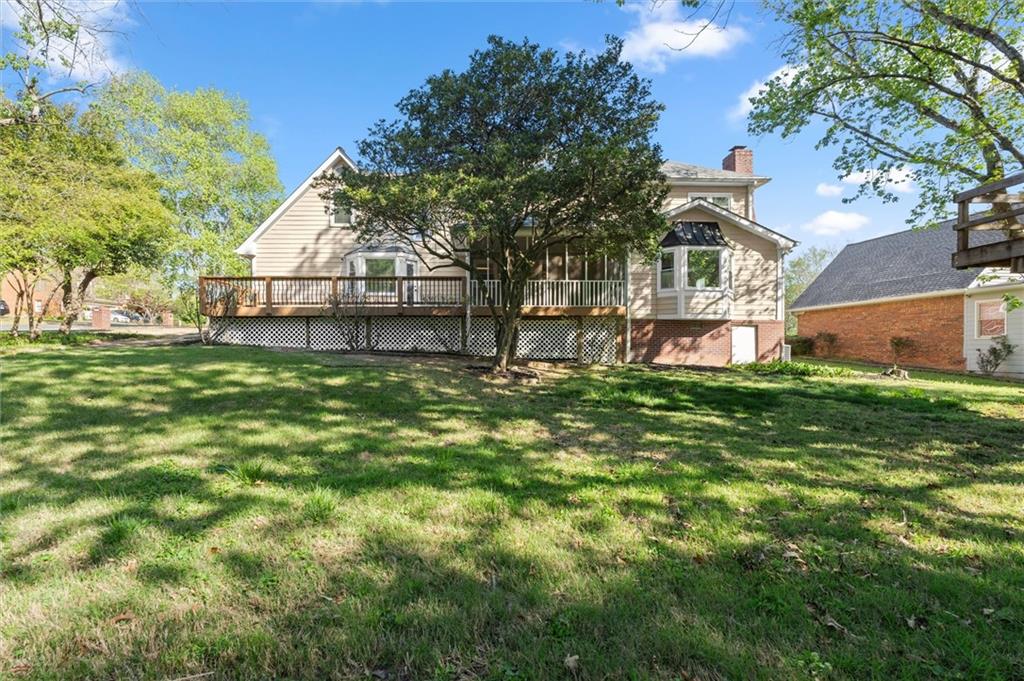 4922 Signal Court Southwest Lilburn, GA 30047 - Photo 48 of 49 a view of a house with a big yard and large tree