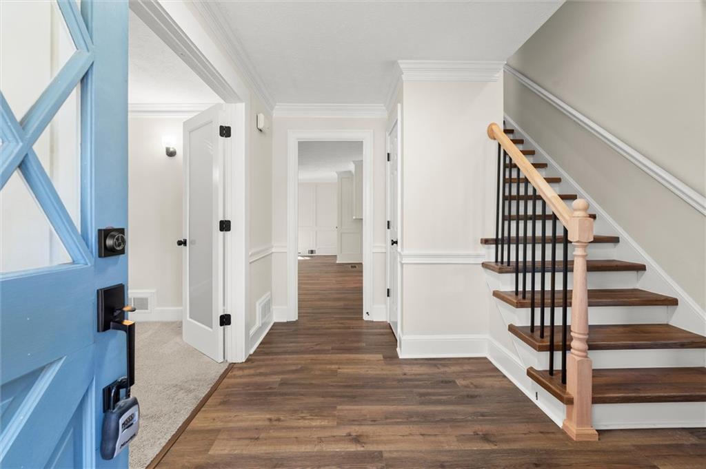4922 Signal Court Southwest Lilburn, GA 30047 - Photo 5 of 49 a view of a hallway with wooden floor and staircase
