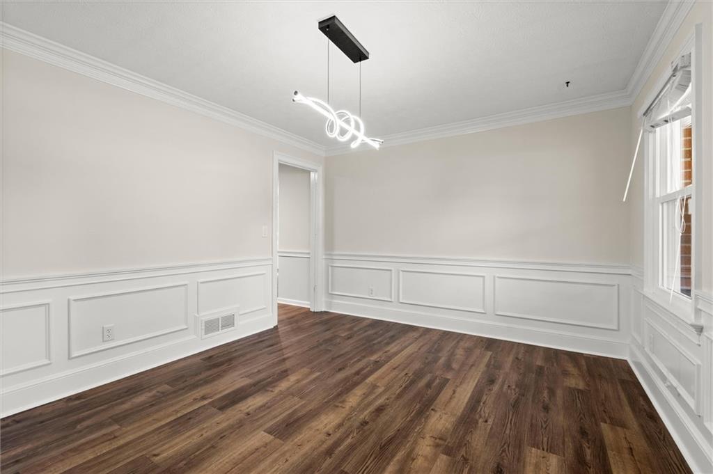 4922 Signal Court Southwest Lilburn, GA 30047 - Photo 7 of 49 wooden floor in an empty room with a window