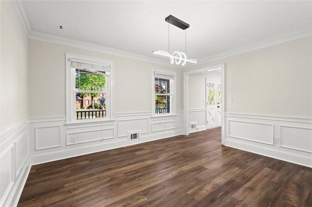 4922 Signal Court Southwest Lilburn, GA 30047 - Photo 8 of 49 a view of an empty room with wooden floor fridge and a window
