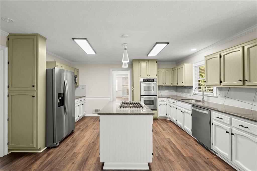 4922 Signal Court Southwest Lilburn, GA 30047 - Photo 10 of 49 a kitchen with stainless steel appliances a sink stove and refrigerator