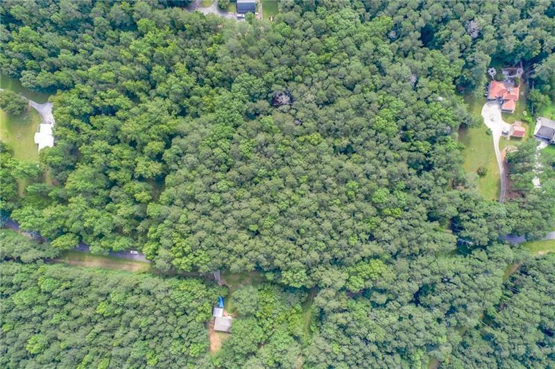 0 Old Grogan Road Acworth, GA 30101 - Photo 12 of 13 a view of a house with a lush green forest