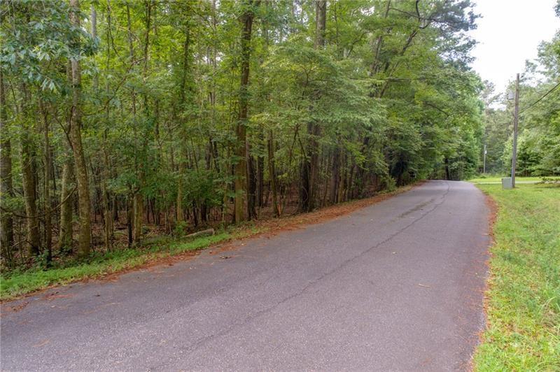 0 Old Grogan Road Acworth, GA 30101 - Photo 2 of 13 a view of a field with trees in the background