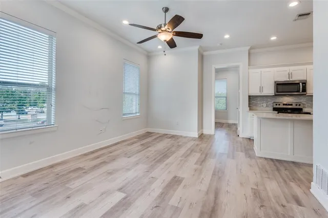 a kitchen with a sink a stove a refrigerator and cabinets
