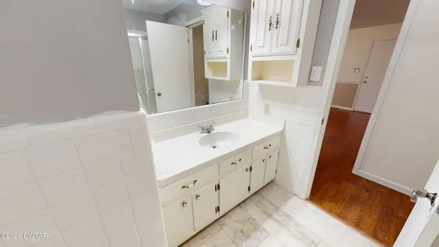 a bathroom with a double vanity sink and mirror