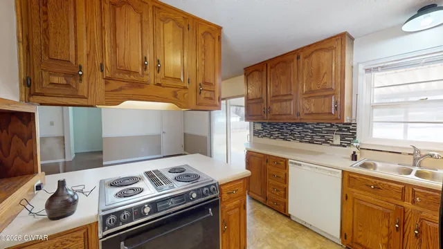 a kitchen with wooden cabinets and a stove top oven