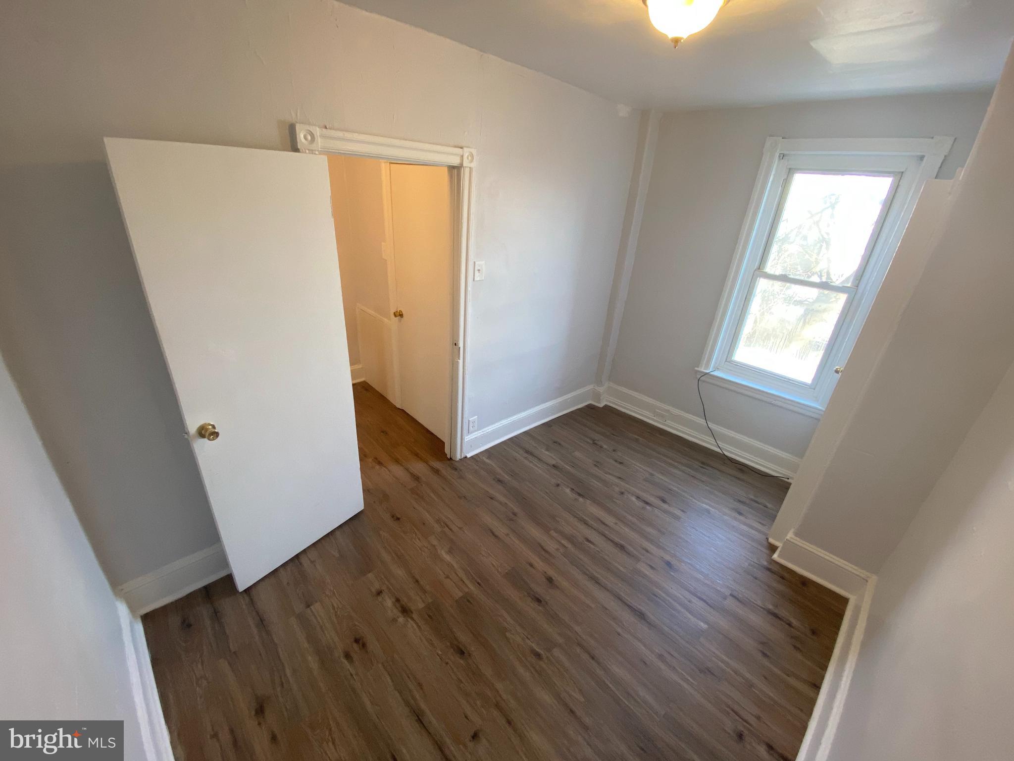235 North Avondale Street Philadelphia, PA 19139 - Photo 8 of 8 an empty room with wooden floor and windows