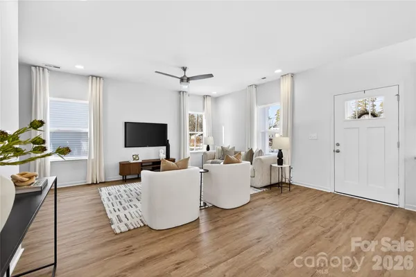 a living room with furniture flat screen tv and a fireplace