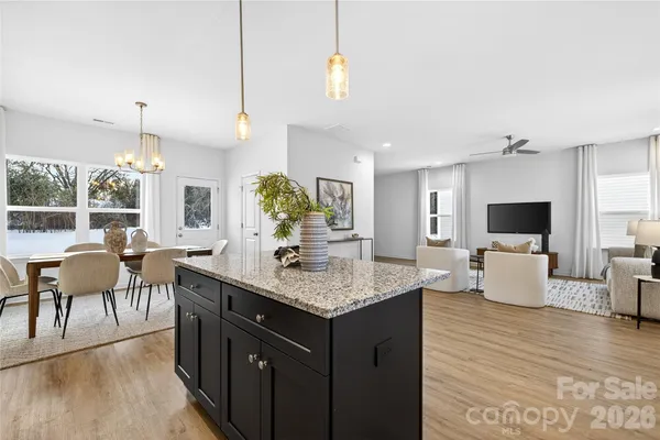 a living room with furniture a wooden floor and a flat screen tv