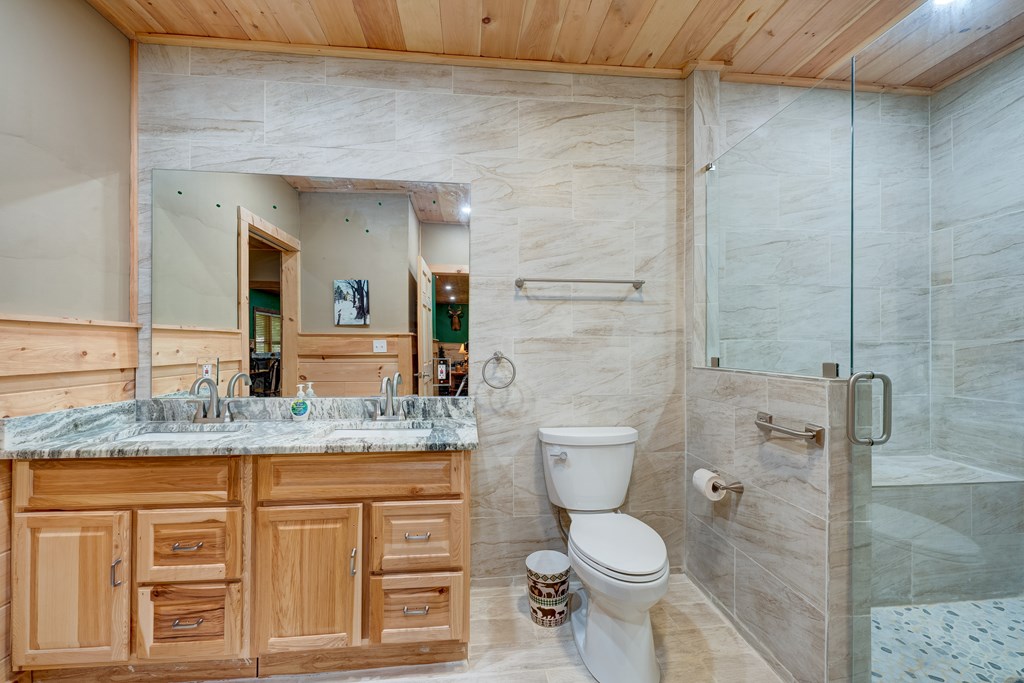 30 The Forest Road Blue Ridge, GA 30513 - Photo 37 of 47 a bathroom with a granite countertop toilet sink and mirror
