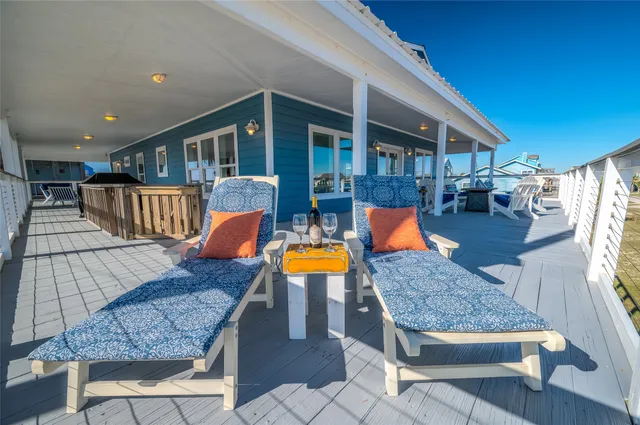 a living room with furniture kitchen view and a large window