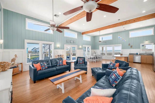 a kitchen with stainless steel appliances granite countertop a stove top oven a sink and a chairs