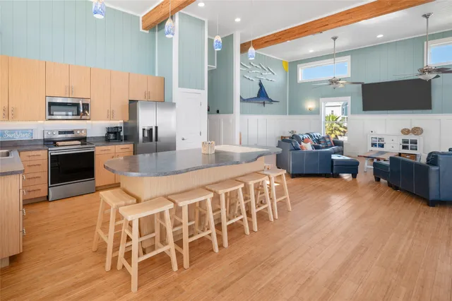 a kitchen with granite countertop a sink stainless steel appliances and cabinets