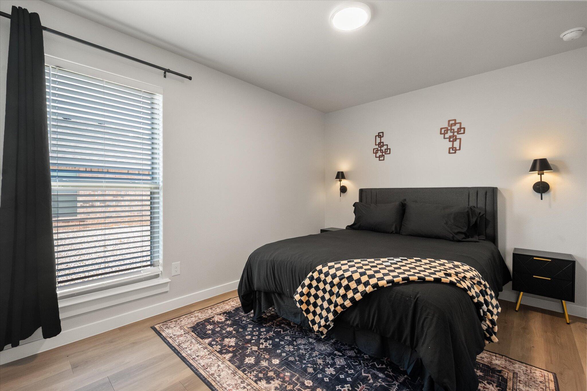 2146 Kokomo Avenue Lubbock, TX 79407 - Photo 9 of 10 a bedroom with a bed and wooden floor