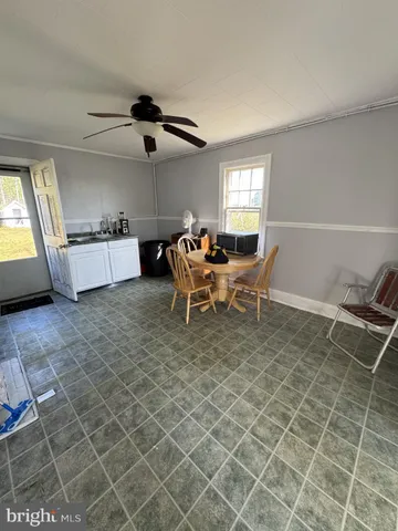 a dining room with furniture and a window