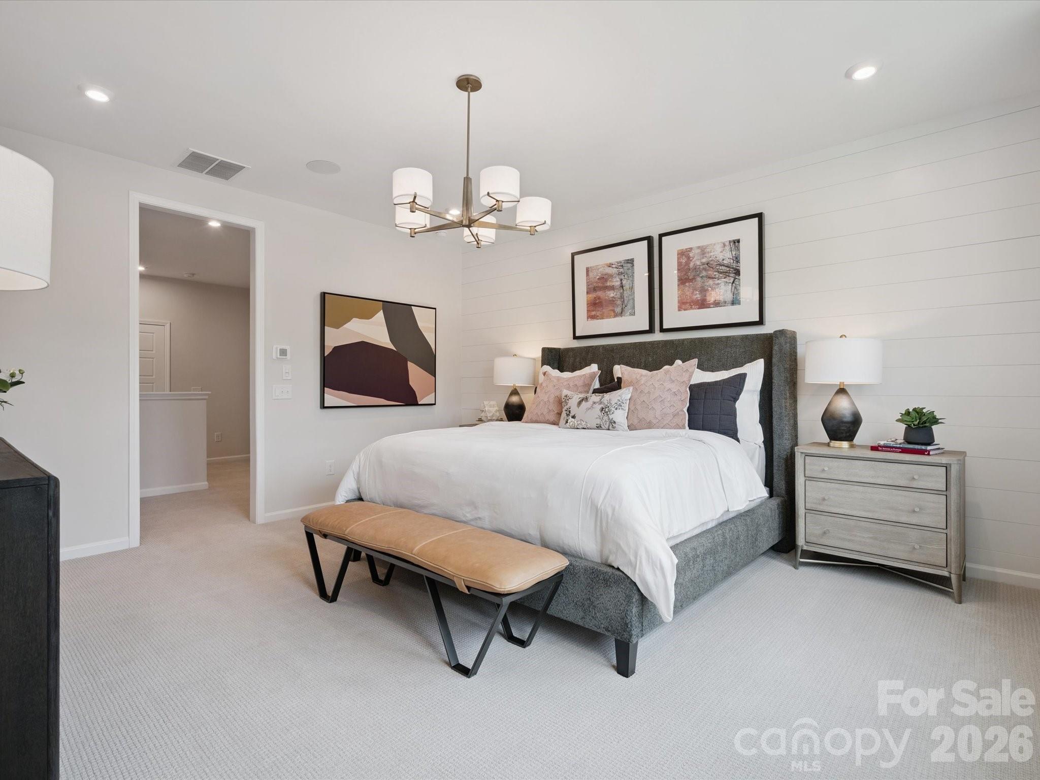 604 Webster Lane Cramerton, NC 28032 - Photo 16 of 20 a spacious bedroom with a bed and a chandelier