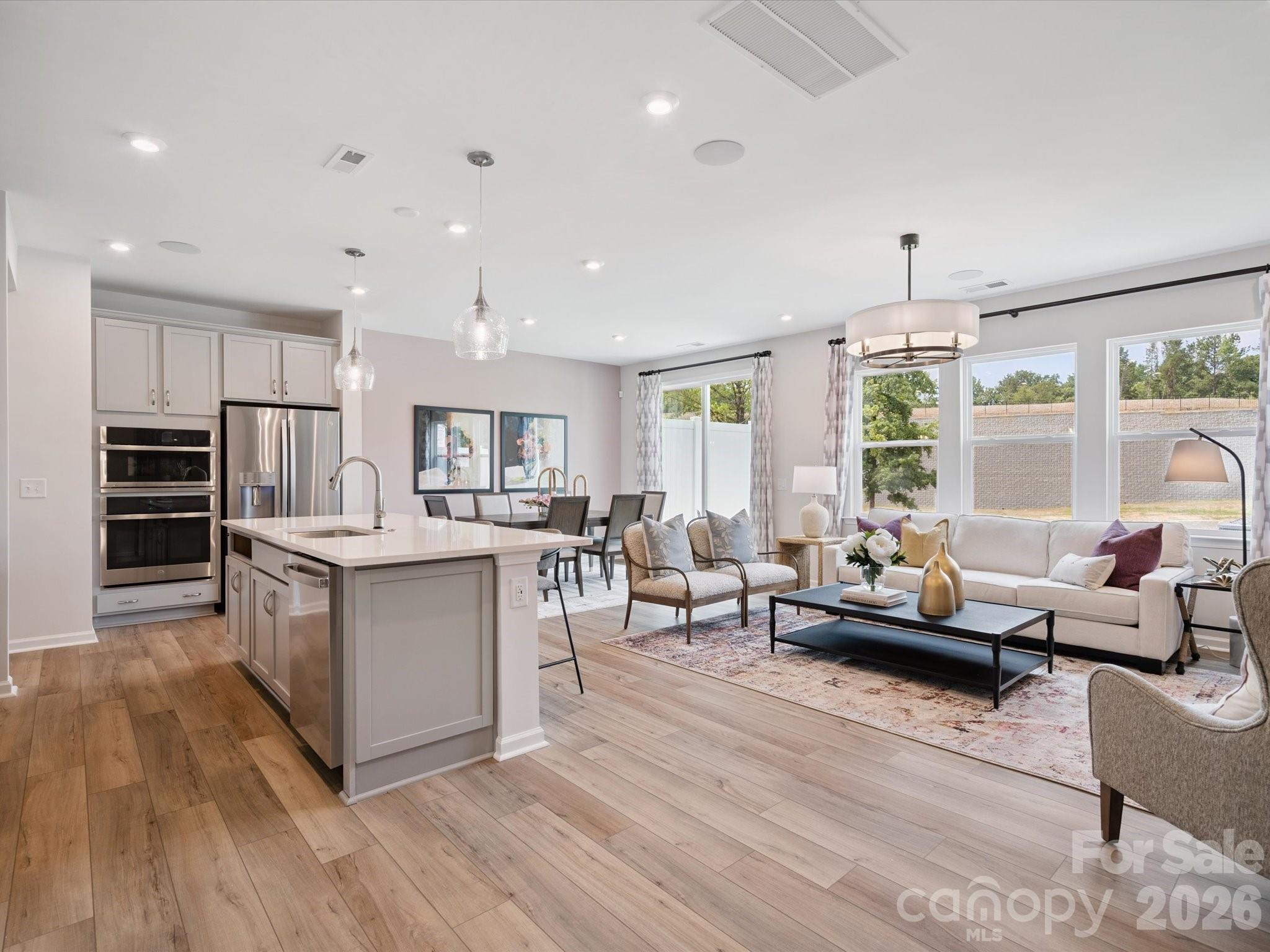 604 Webster Lane Cramerton, NC 28032 - Photo 7 of 20 a living room with stainless steel appliances kitchen island granite countertop a large window and a view of kitchen