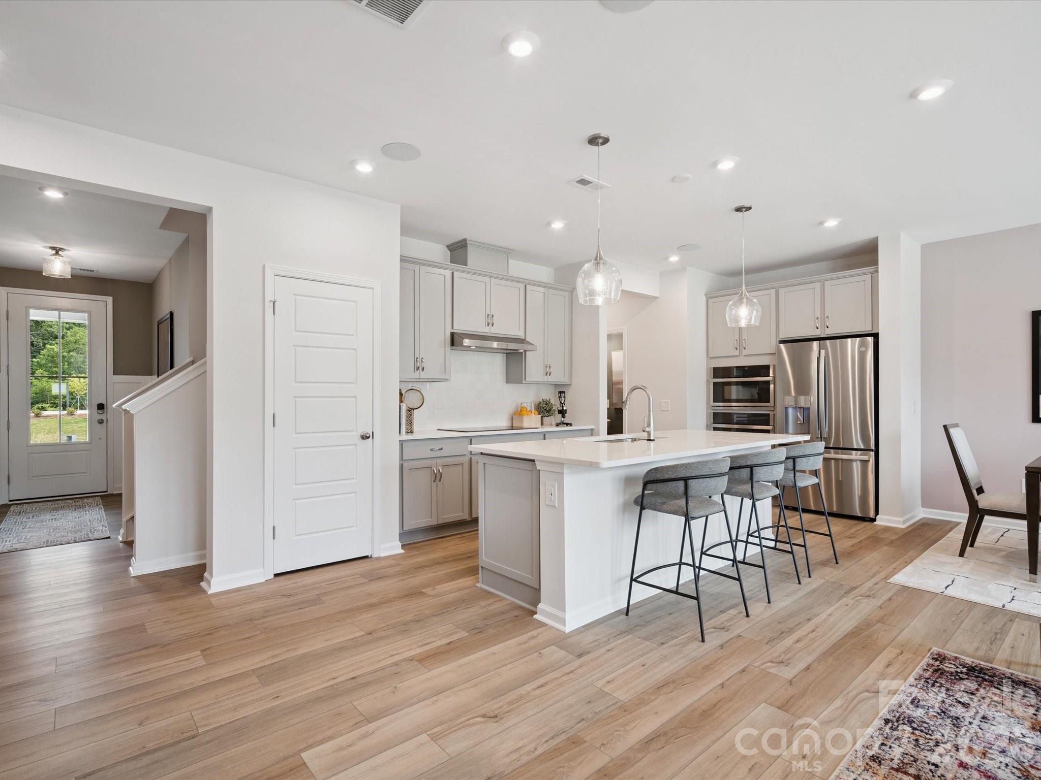 604 Webster Lane Cramerton, NC 28032 - Photo 8 of 20 a kitchen with white cabinets and stainless steel appliances
