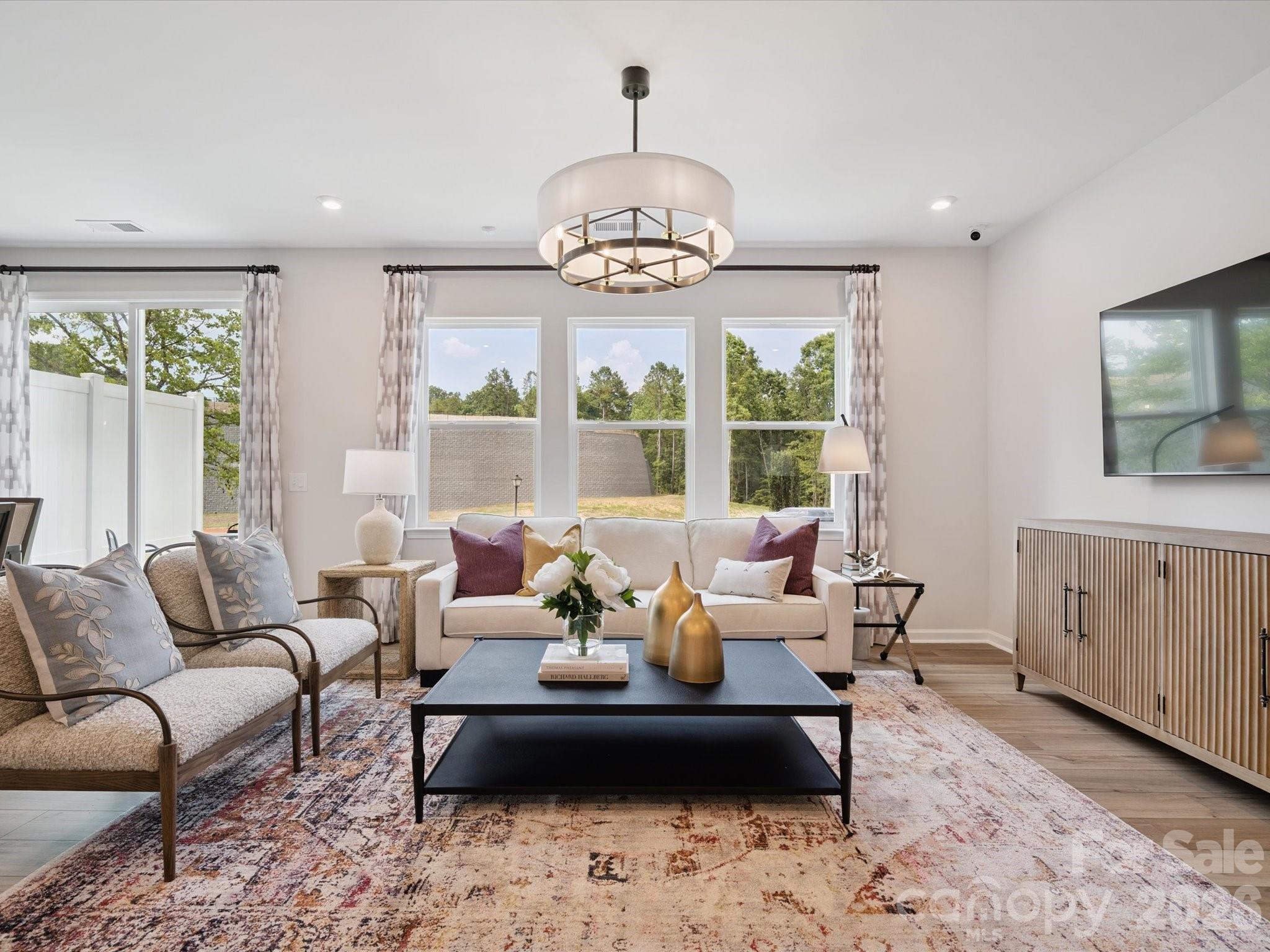 604 Webster Lane Cramerton, NC 28032 - Photo 10 of 20 a living room with furniture and a chandelier