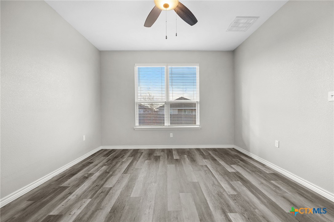 7713 Purvis Street Temple, TX 76502 - Photo 13 of 29 wooden floor in an empty room with a window
