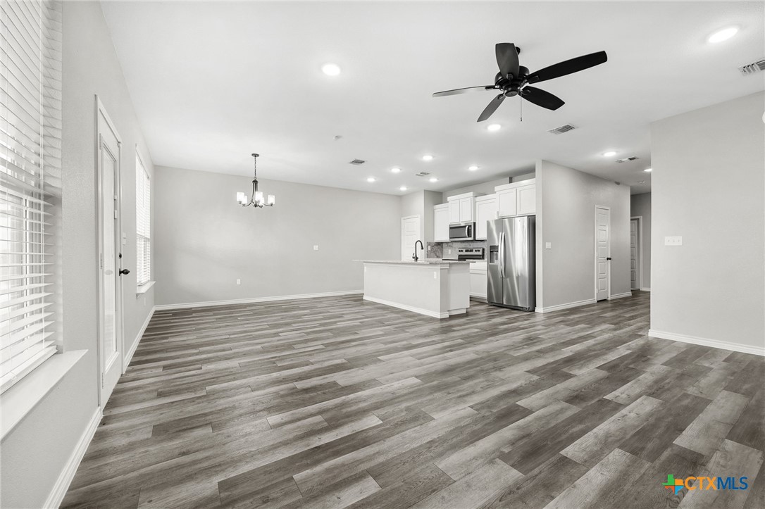 7713 Purvis Street Temple, TX 76502 - Photo 6 of 29 a view of a livingroom with a ceiling fan kitchen appliances and a window