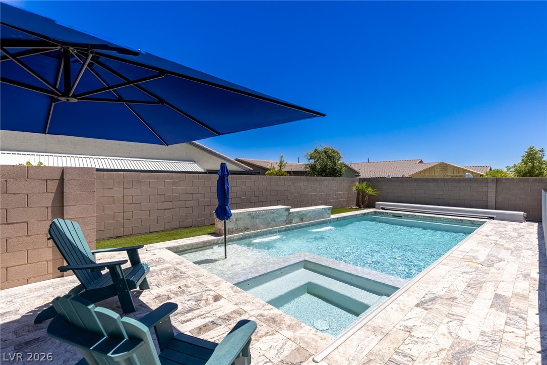 7036 Arabian Ridge Street Las Vegas, NV 89131 - Photo 47 of 64 Sparkling pool and spa with an automated cover, cantilever umbrella, and safety fence perfect for escaping those hot summer days.