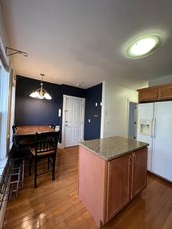 a kitchen with kitchen island a counter top space a sink and appliances