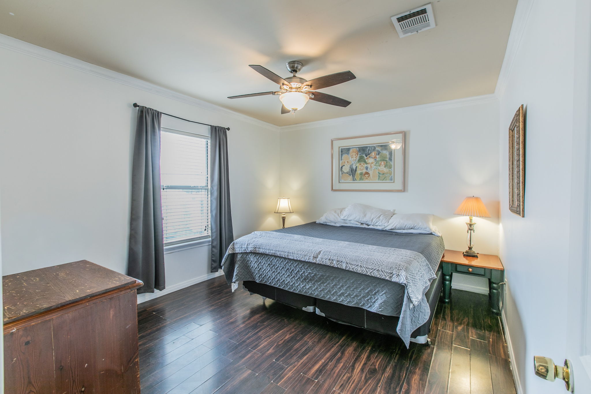 1107 Vargas Road Austin, TX 78741 - Photo 8 of 17 Rich hardwood floors complement the natural light in this inviting bedroom.