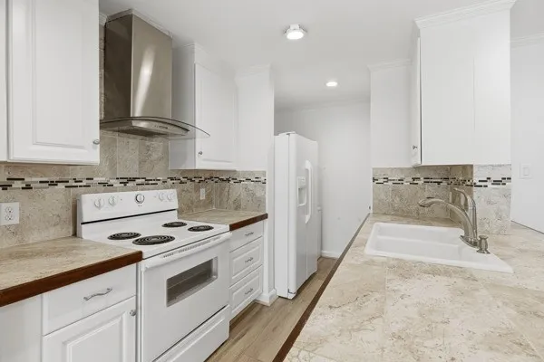 a kitchen with stainless steel appliances granite countertop a stove a sink and a refrigerator