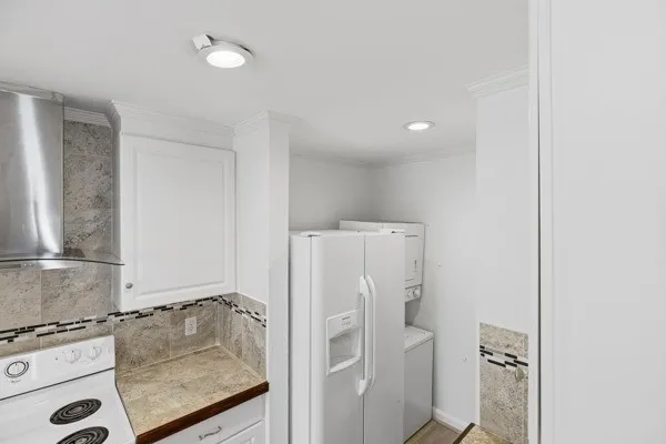 a bathroom with a granite countertop shower a sink and a stove