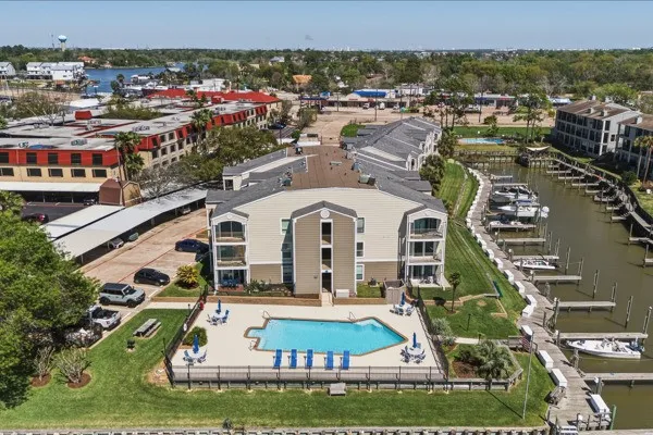 a view of a big building with a big yard and large trees