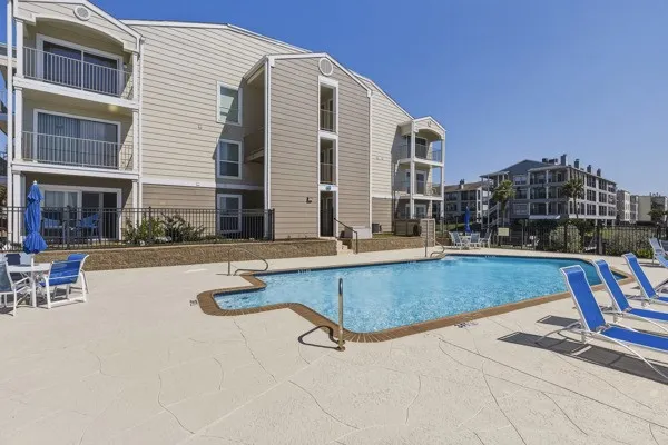 a swimming pool with outdoor seating and yard