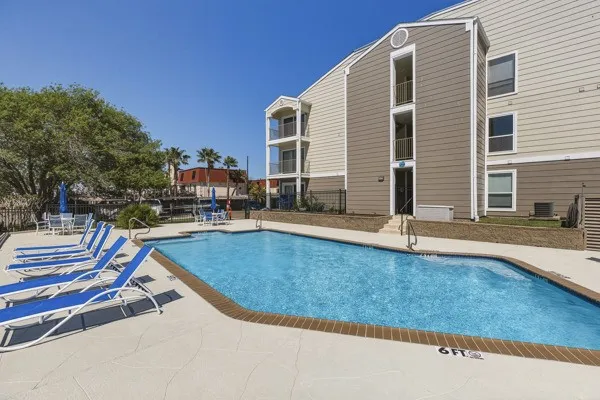 a view of a house with swimming pool and sitting area