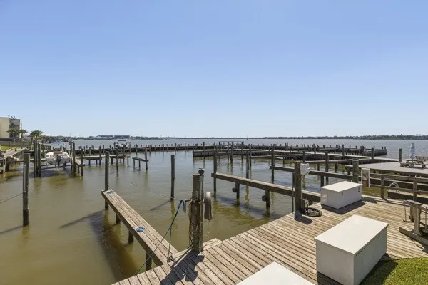 a view of a roof deck with couches and ocean view
