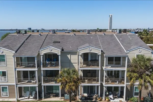 a front view of a residential apartment building with a yard