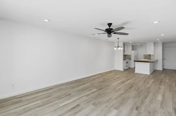a view of a kitchen with a sink and a chandelier fan