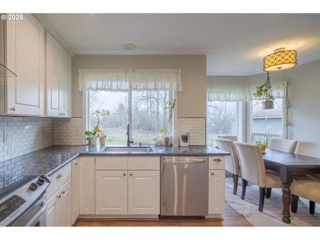 a kitchen with granite countertop a sink and cabinets