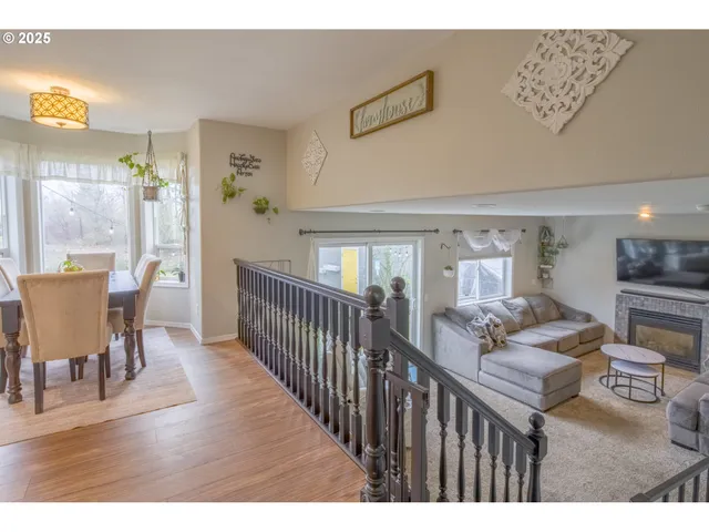 a living room with furniture a wooden floor and next to a window