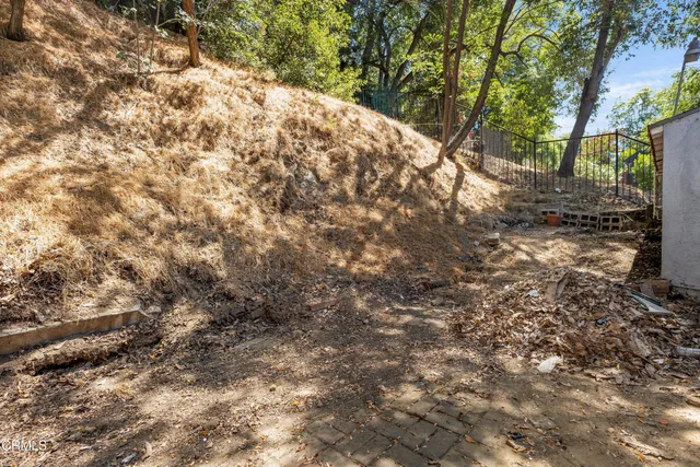 a backyard of a house with large trees