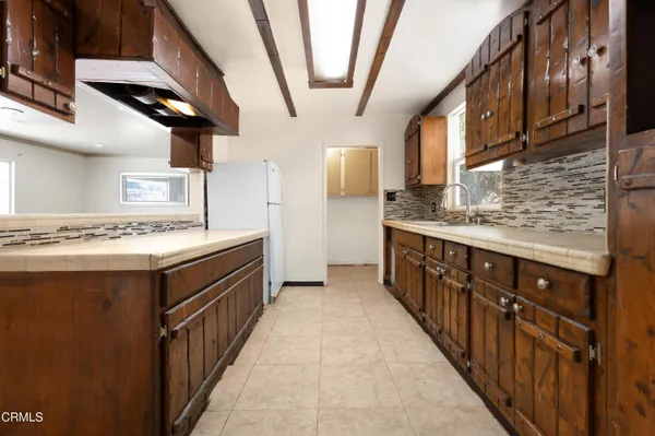a kitchen with stainless steel appliances granite countertop a sink and a stove