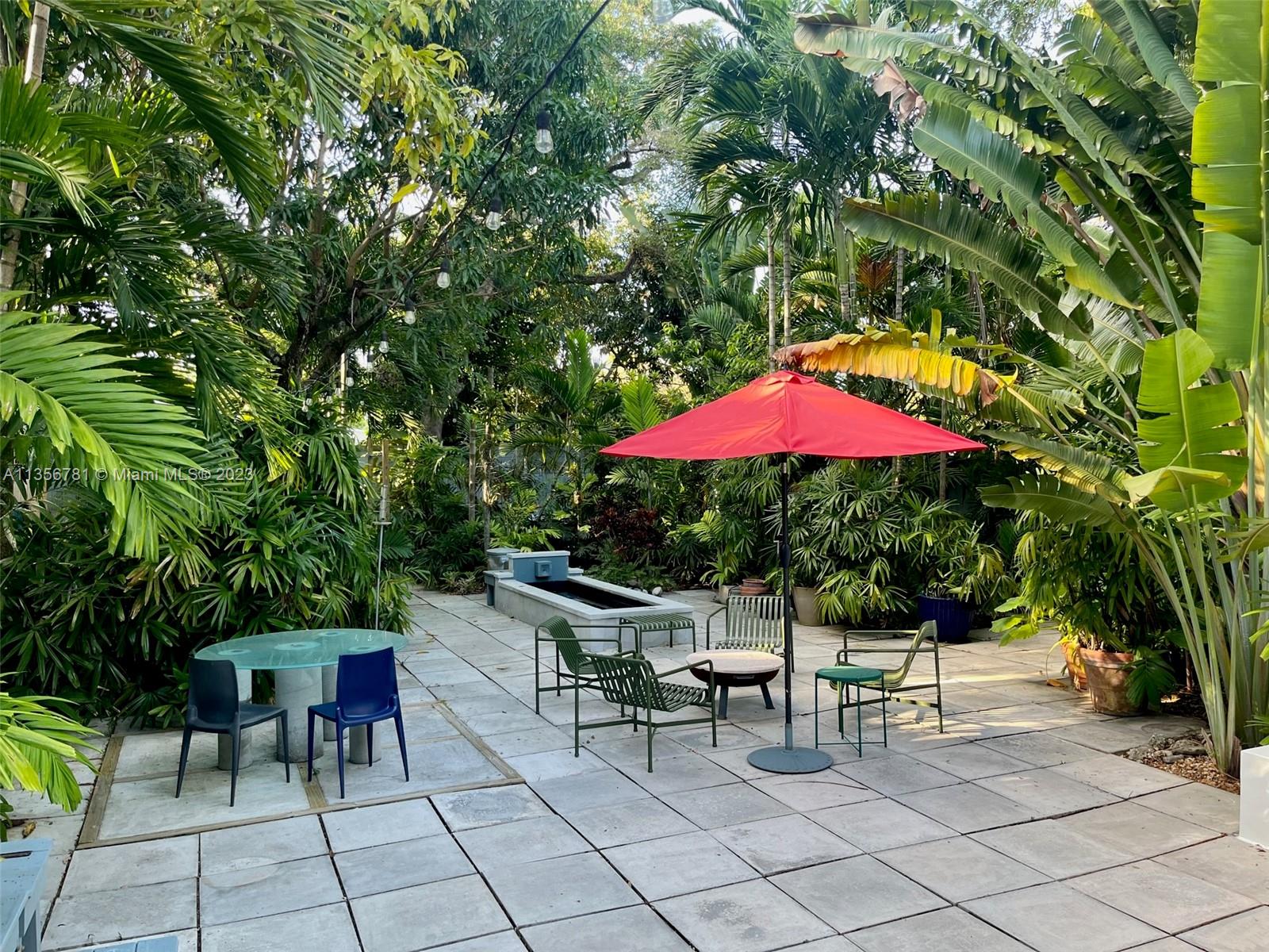 Bayside Miami, FL 33138 - Photo 3 of 8 an outdoor space with furniture and umbrella