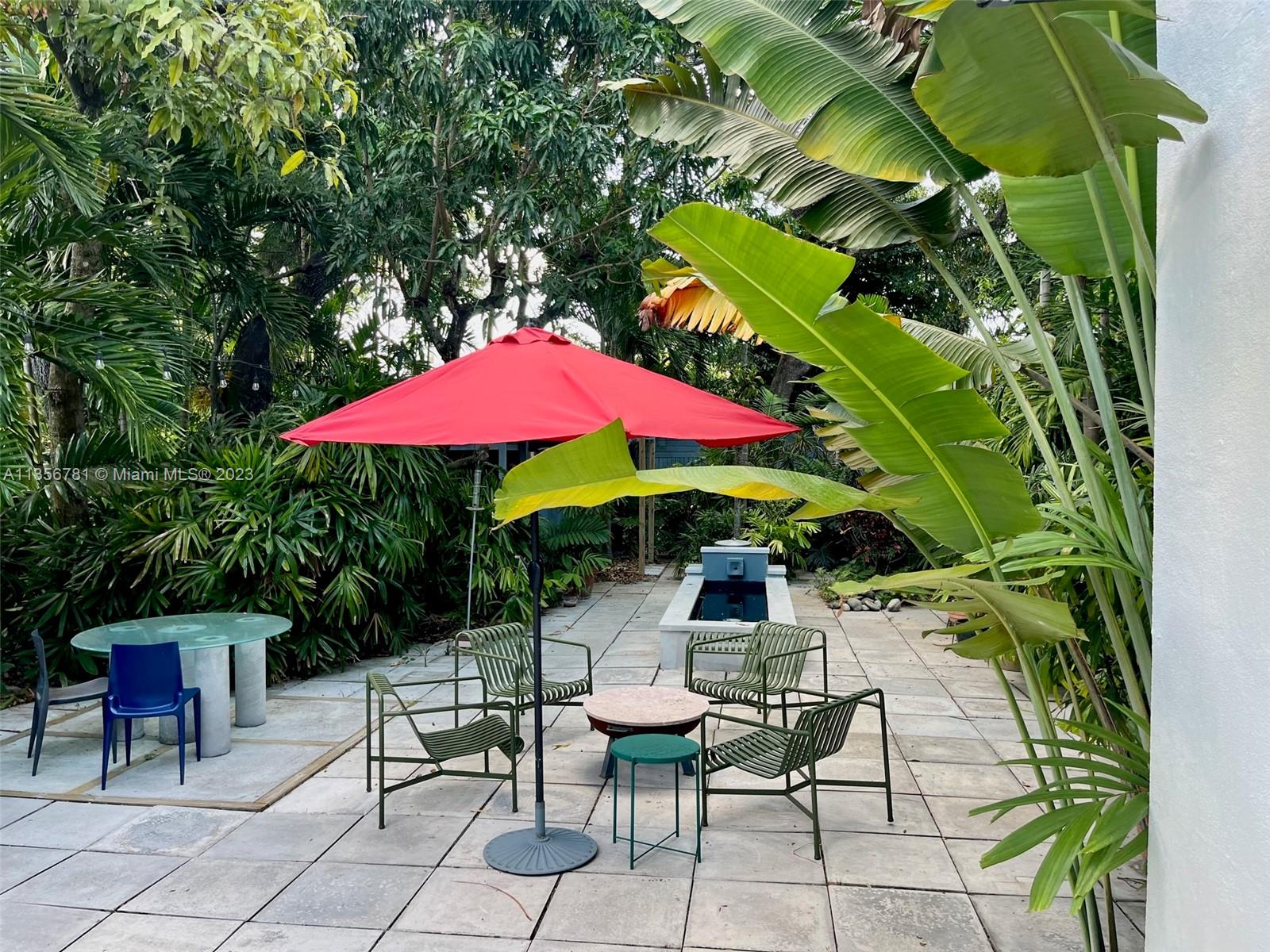 Bayside Miami, FL 33138 - Photo 4 of 8 an outdoor space with furniture and umbrella