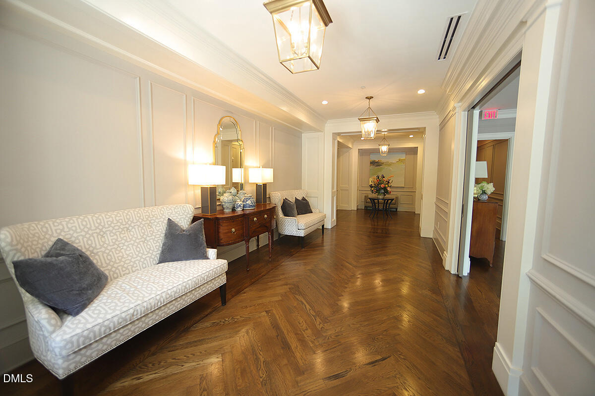 620 Wade Avenue, Unit 206 Raleigh, NC 27605 - Photo 13 of 42 a living room with furniture and a chandelier