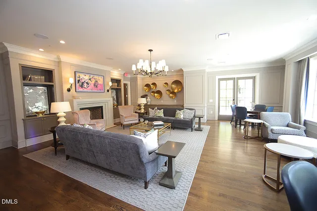 a living room with fireplace furniture and a chandelier