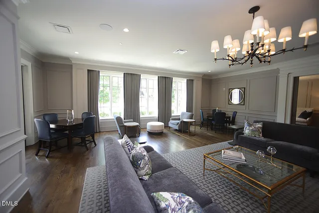 a living room with furniture and a chandelier
