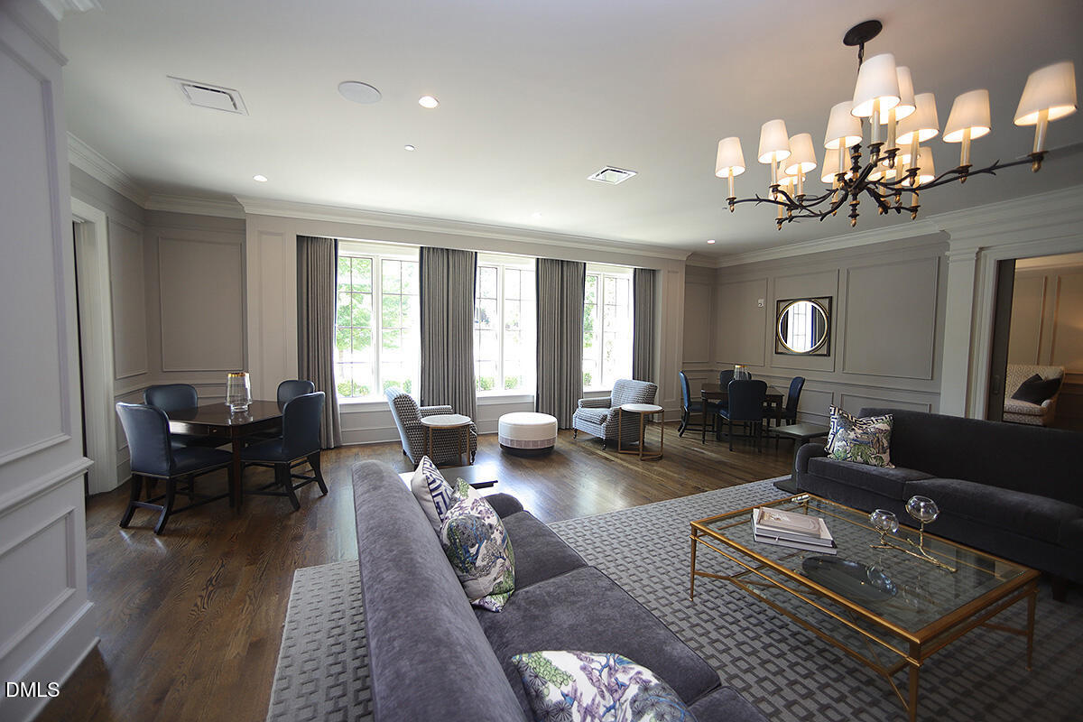 620 Wade Avenue, Unit 206 Raleigh, NC 27605 - Photo 15 of 42 a living room with furniture and a chandelier