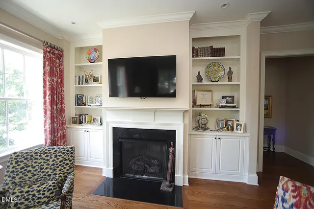 a living room with a fireplace and a flat screen tv