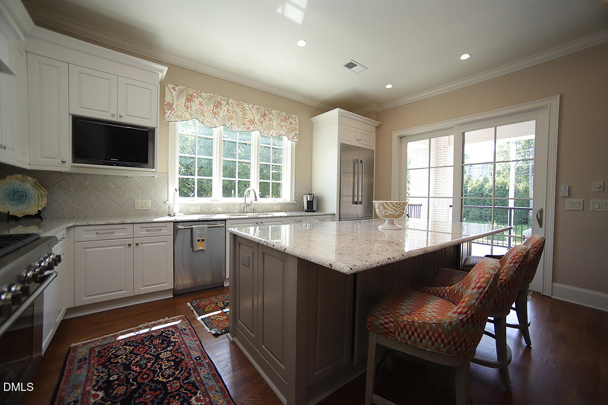 620 Wade Avenue, Unit 206 Raleigh, NC 27605 - Photo 25 of 42 a kitchen with granite countertop a sink and a stove