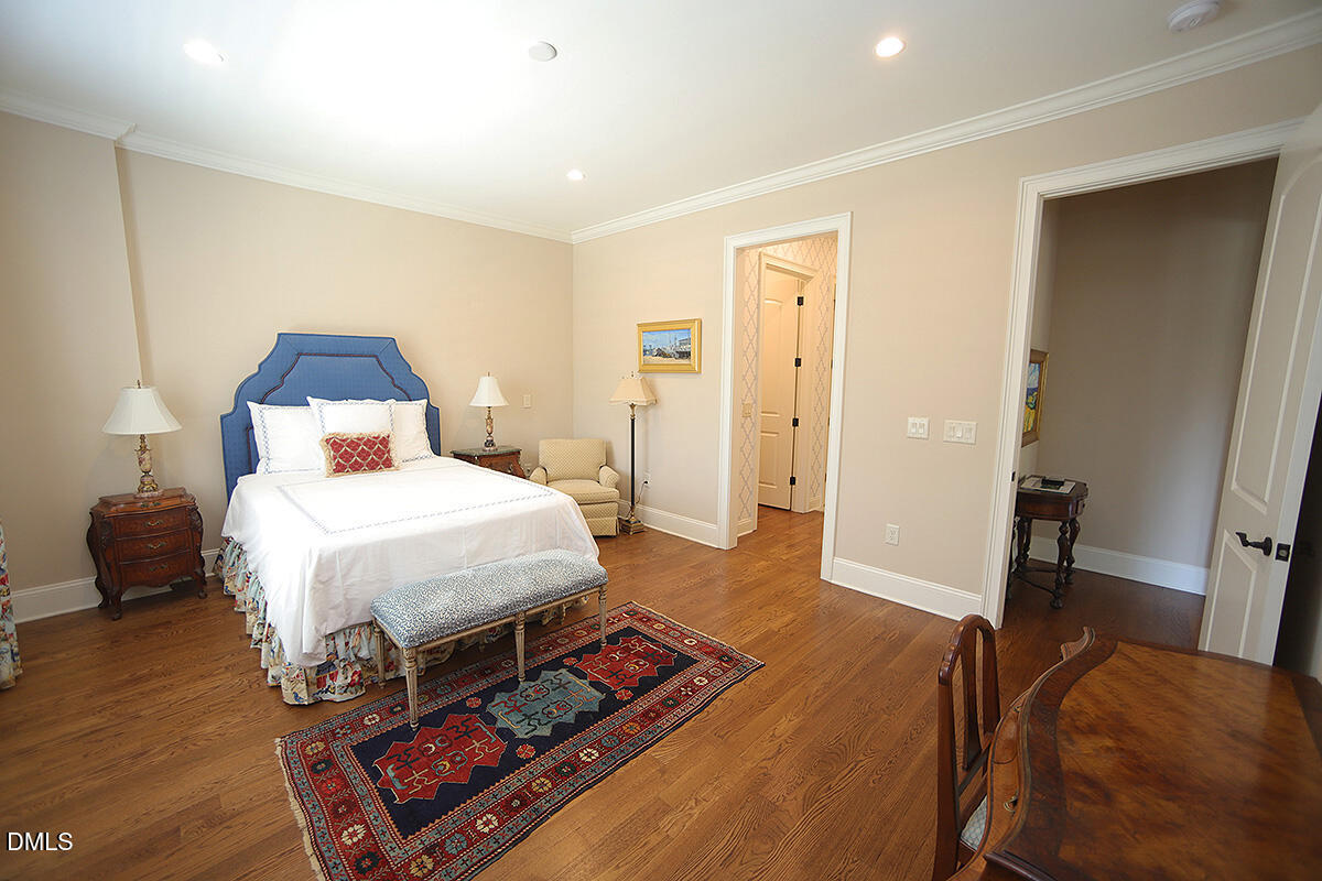 620 Wade Avenue, Unit 206 Raleigh, NC 27605 - Photo 31 of 42 a bedroom with a bed and wooden floor